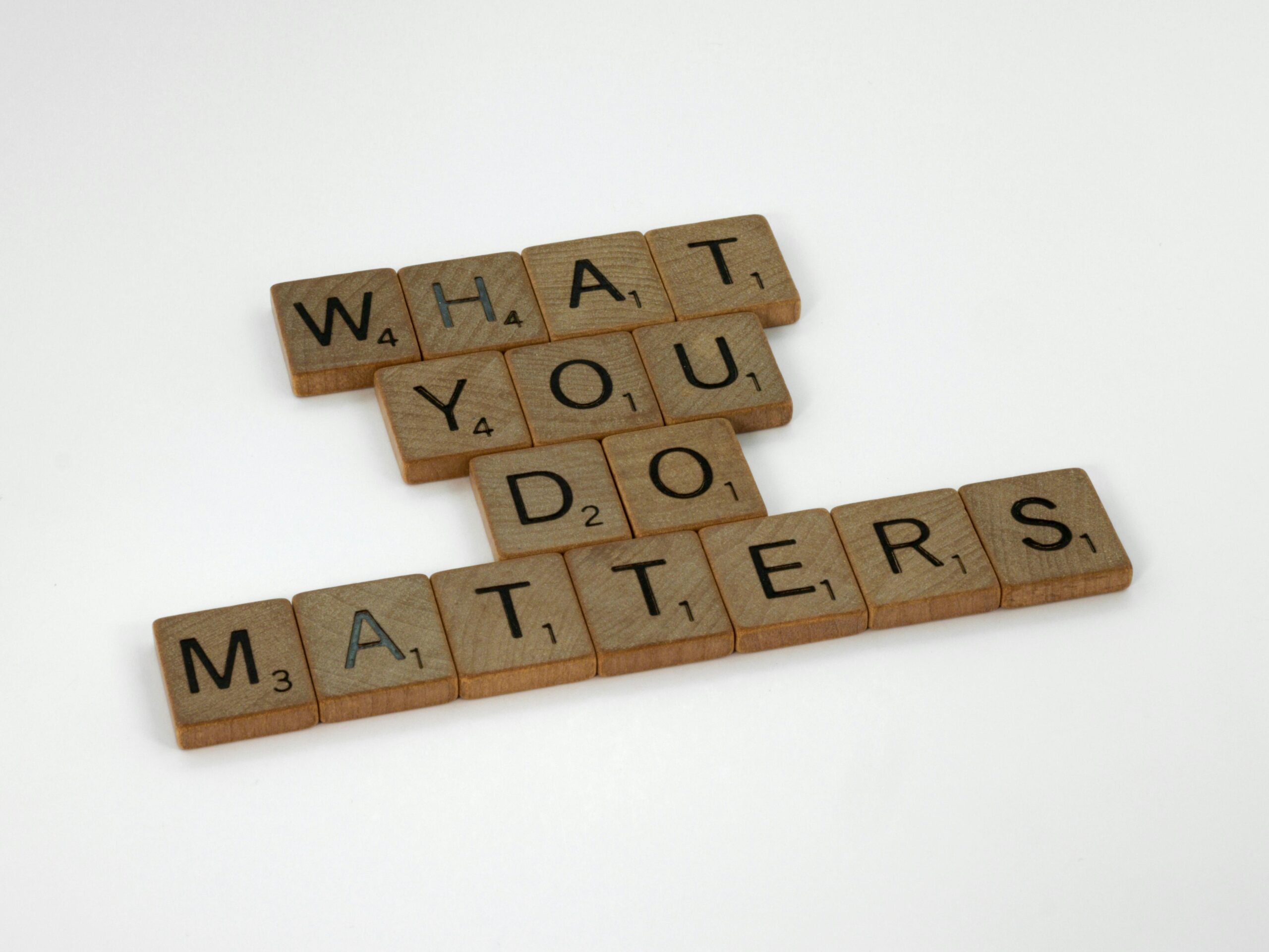 Wooden letter tiles spelling 'What You Do Matters' on a neutral background.